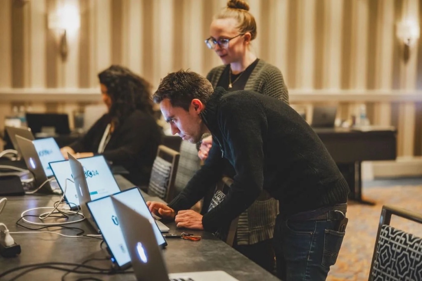 Speakers previewing and editing their presentations at speaker ready kiosks
