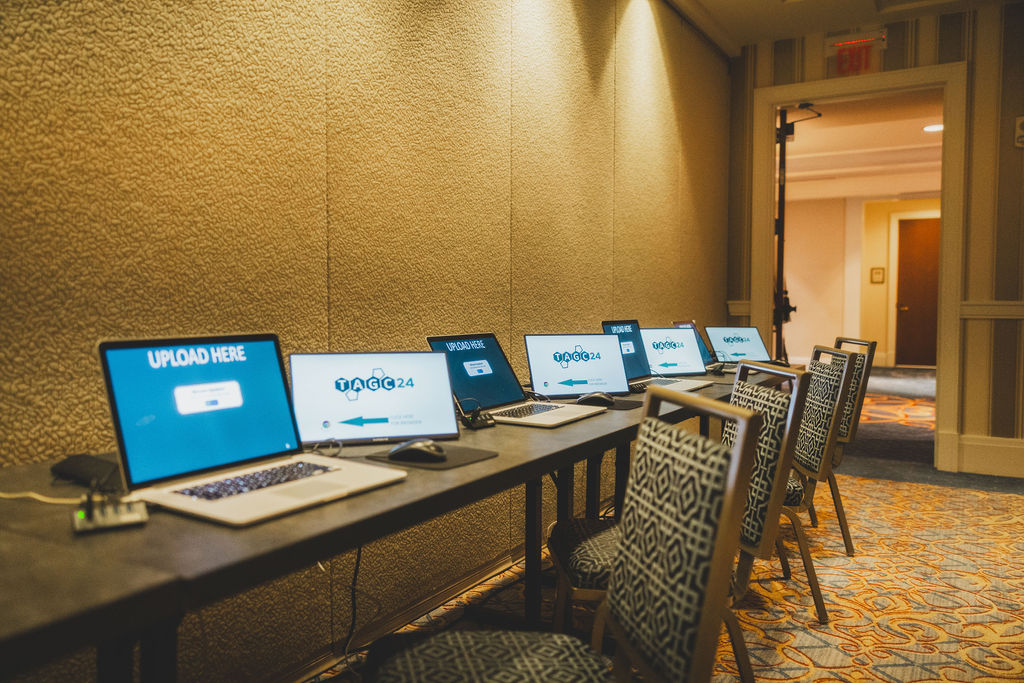 A row of LaunchPad upload stations set up for TAGC 2024